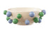 Decorative bowl with green and blue spherical embellishments on a white background